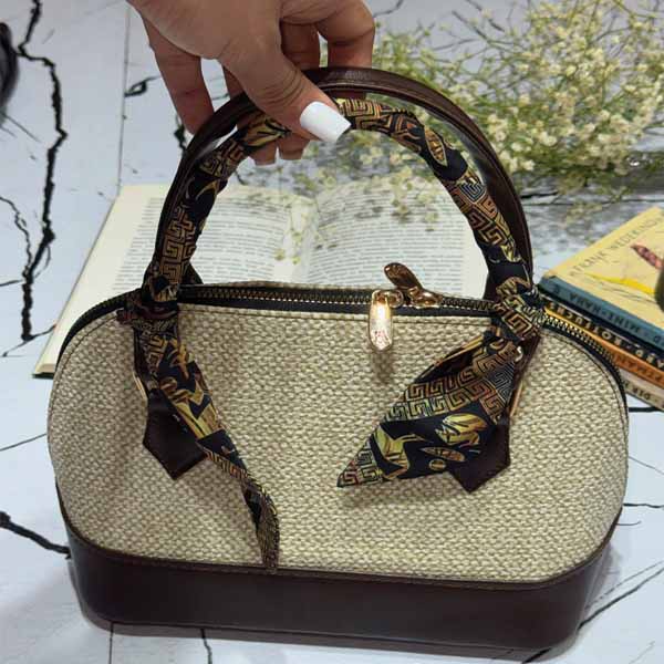 کیف دستی چرم زنانه مدل پارچه‌پیچ